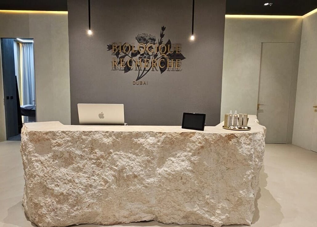 Reception desk at Expert Center, Dubai, Dubai, AE, with a rustic stone counter.