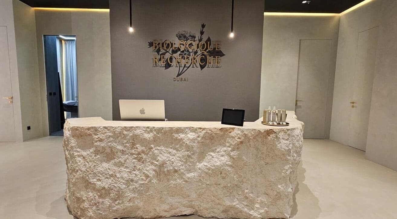 Reception desk at Expert Center, Dubai, Dubai, AE, with a rustic stone counter.