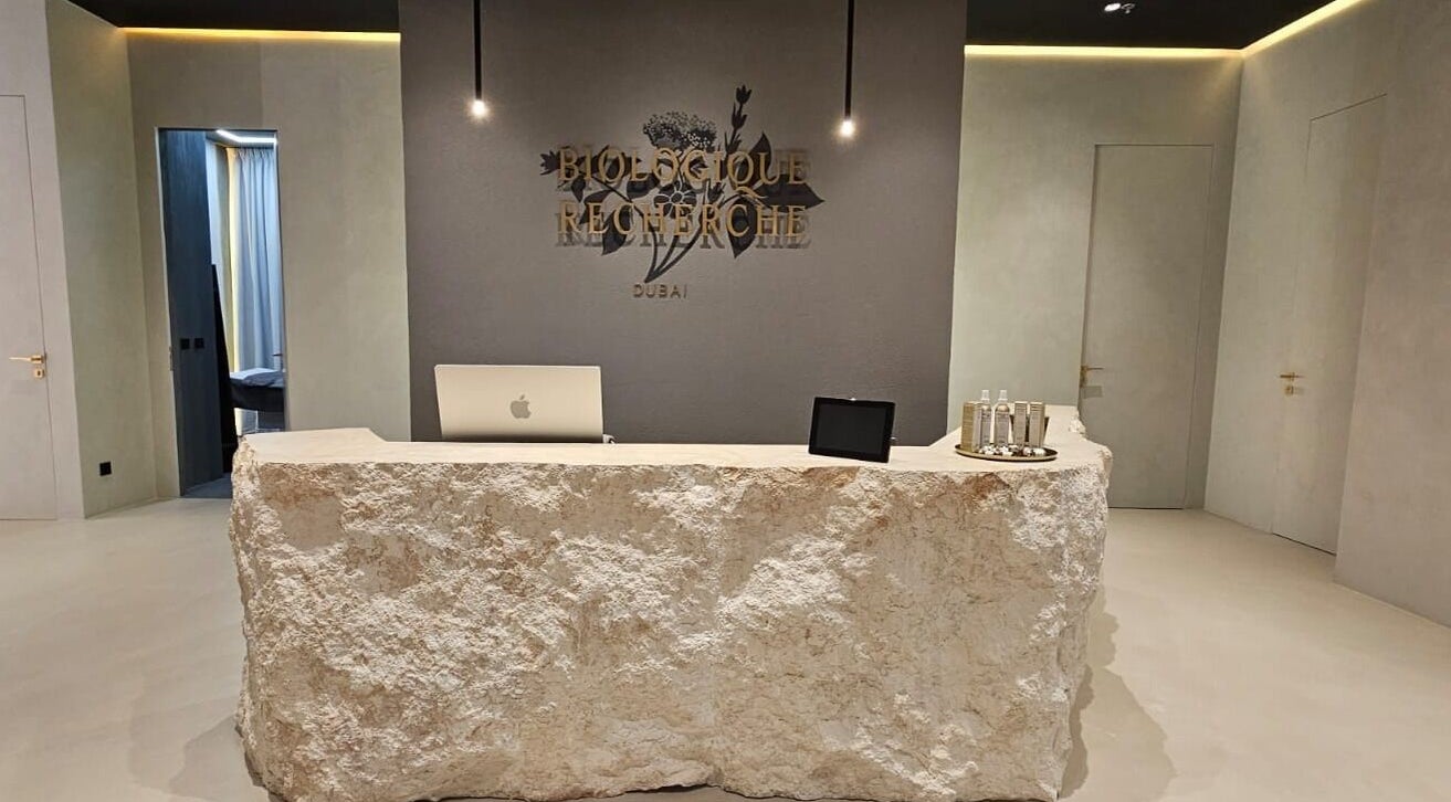 Reception desk at Expert Center, Dubai, Dubai, AE, with a rustic stone counter.
