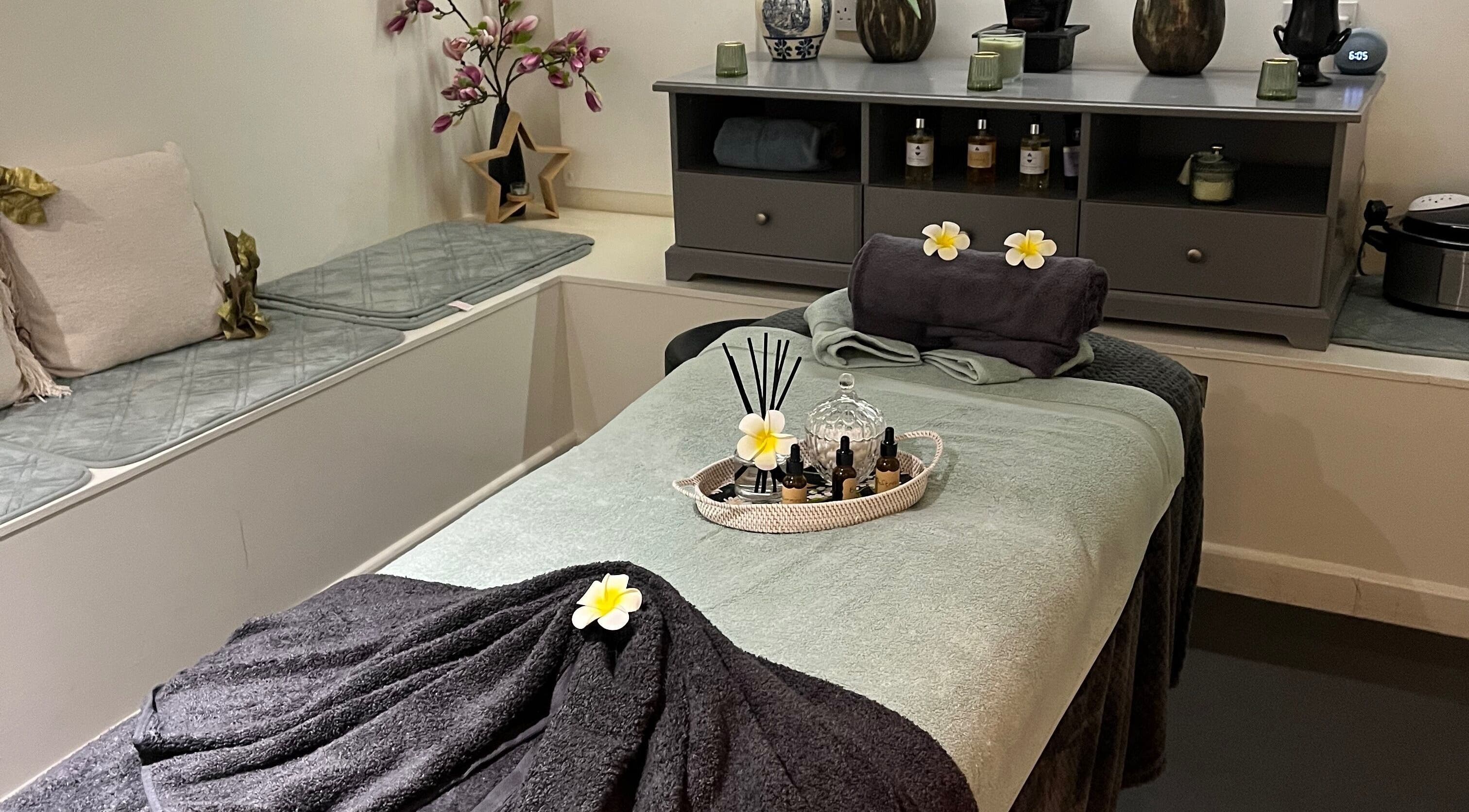 Relaxing spa room setup at Legazi Legacy Hair and Beauty, Gravesend, England, GB with massage table and aromatic oils.