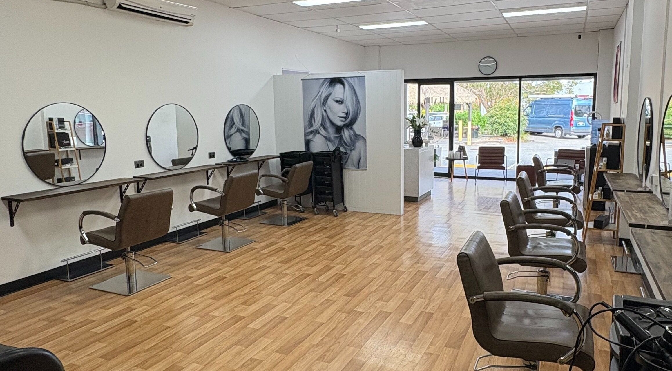Interior of Hair on Hansford salon in Coombabah, Queensland, AU, featuring modern styling chairs and mirrors.
