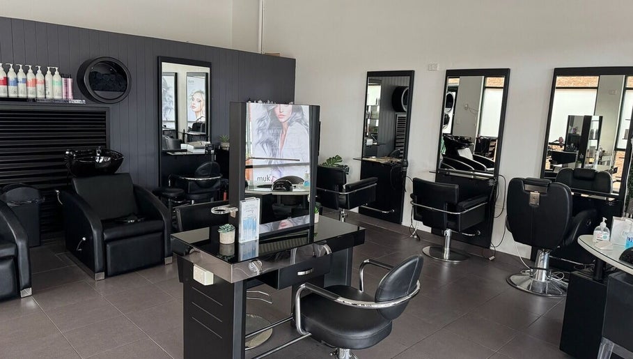 Modern salon interior at Oxenford Hair & Beauty, Oxenford, Queensland, AU with sleek styling stations.