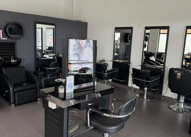 Modern salon interior at Oxenford Hair & Beauty, Oxenford, Queensland, AU with sleek styling stations.