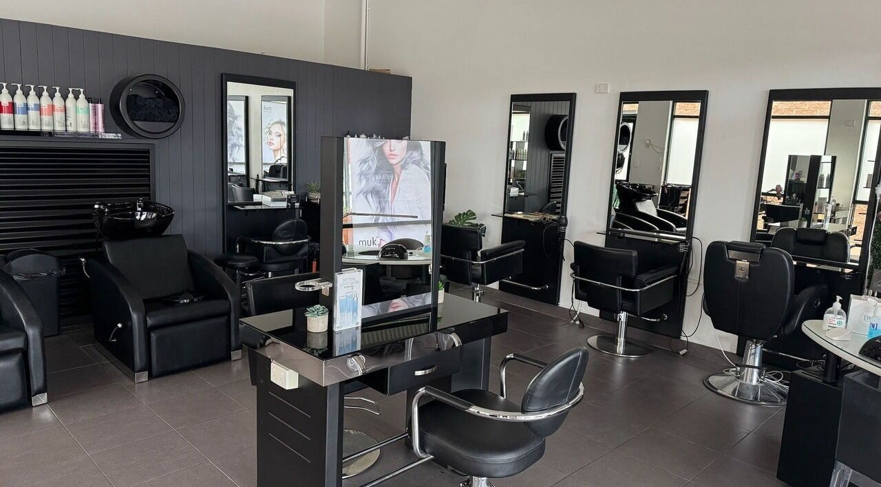 Modern salon interior at Oxenford Hair & Beauty, Oxenford, Queensland, AU with sleek styling stations.