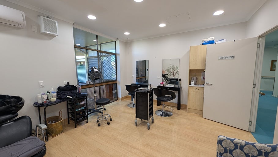 Interior of Arlu Style House salon in Goondiwindi, Queensland, AU featuring stylish hair stations and equipment.