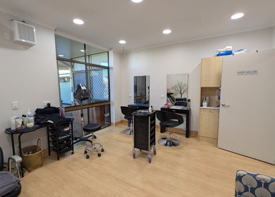Interior of Arlu Style House salon in Goondiwindi, Queensland, AU featuring stylish hair stations and equipment.
