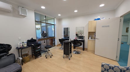Interior of Arlu Style House salon in Goondiwindi, Queensland, AU featuring stylish hair stations and equipment.