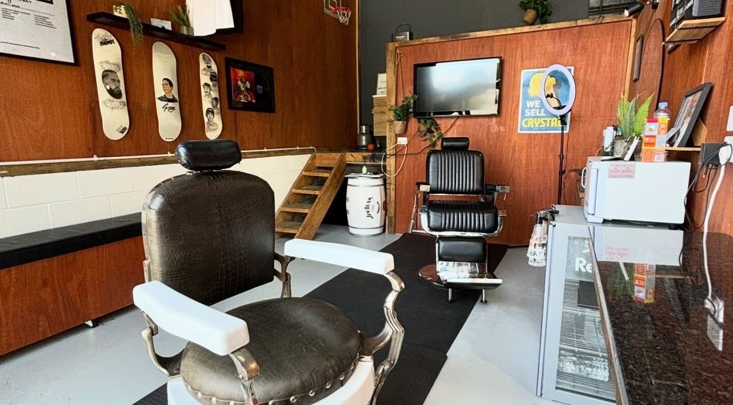 Interior of Stay Cut Barbers in Paraparaumu, Wellington, NZ, featuring stylish chairs and decor.