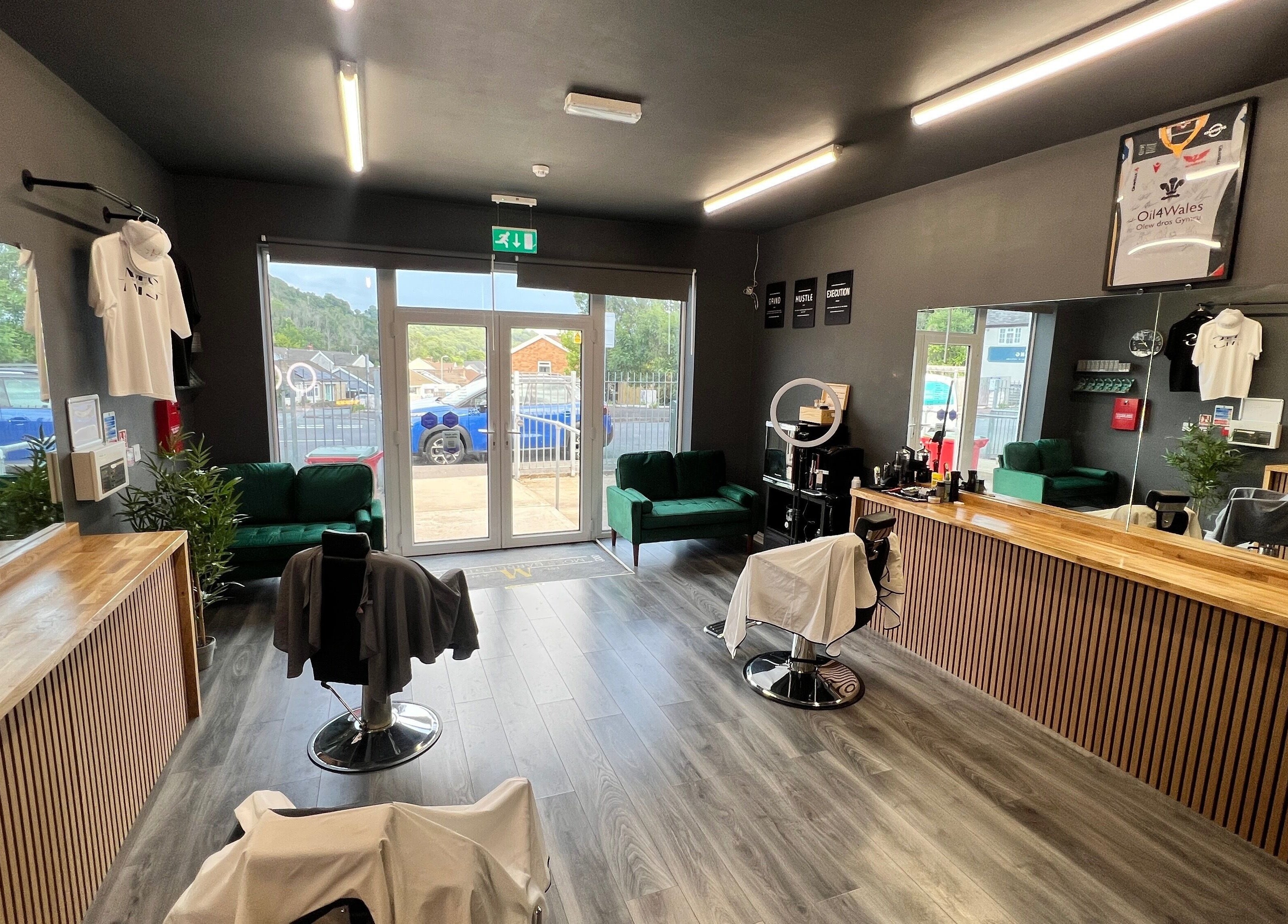 Interior of Moss Barber Studio in Llantrisant, Wales, GB, featuring sleek decor and comfortable seating.