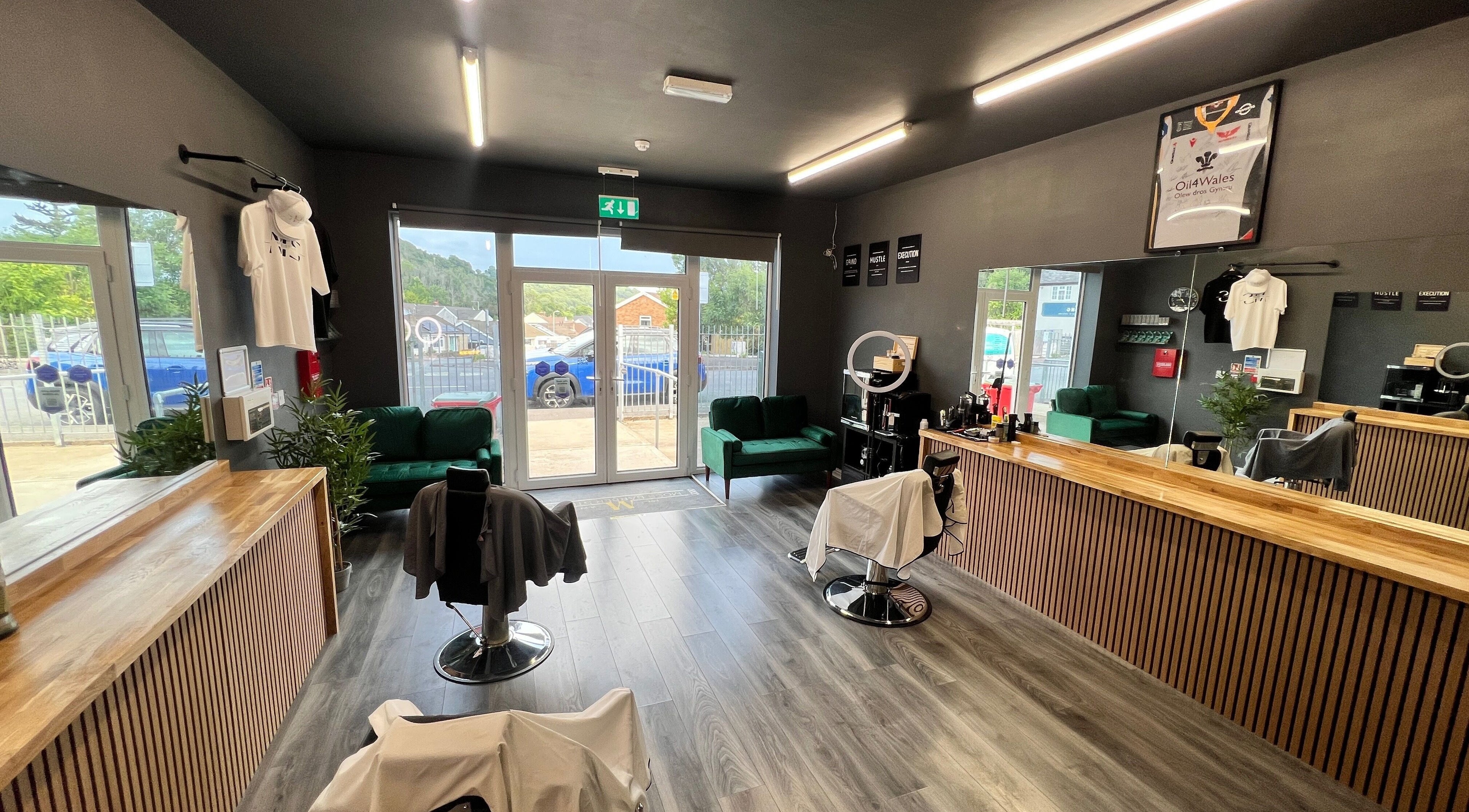 Interior of Moss Barber Studio in Llantrisant, Wales, GB, featuring sleek decor and comfortable seating.