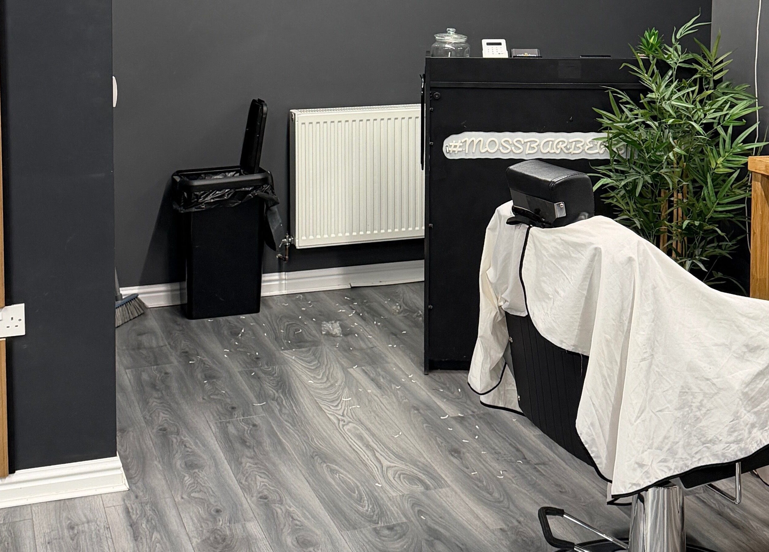 Sleek interior of Moss Barber Studio in Llantrisant, Wales, GB, featuring a barber chair and elegant decor.