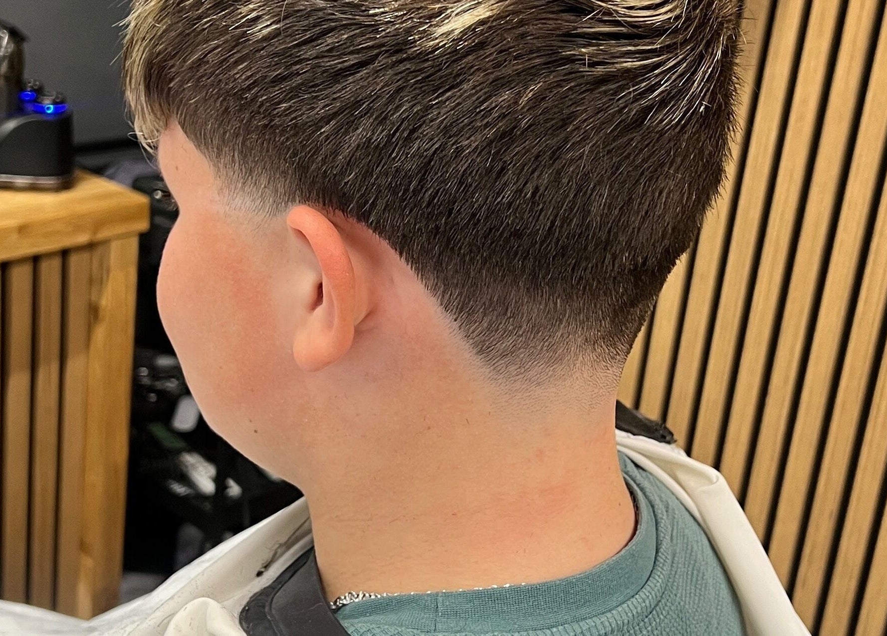 Tapered haircut at Moss Barber Studio in Llantrisant, Wales, GB, showcasing precision styling.