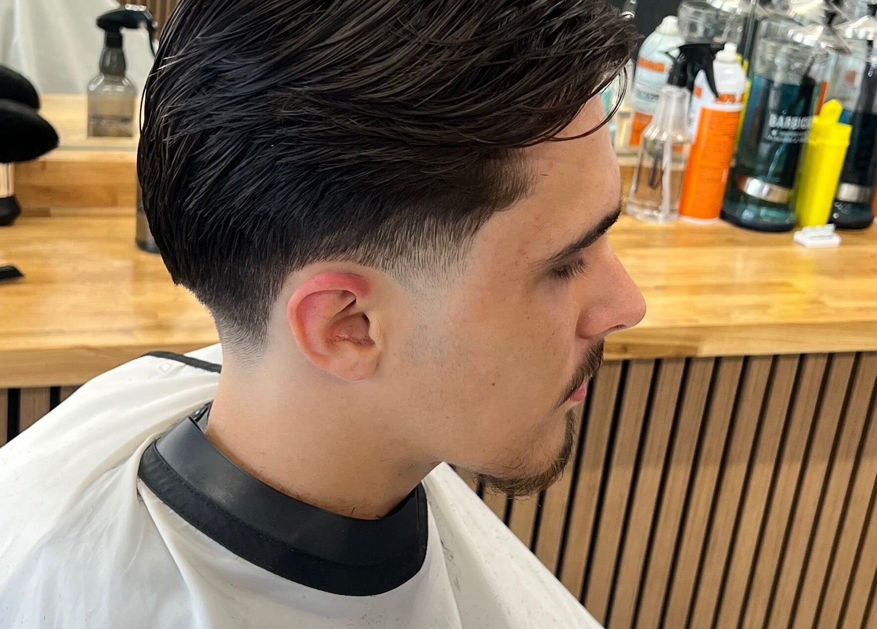 Modern haircut at Moss Barber Studio, Llantrisant, Wales, GB, showcasing sleek styling and professional grooming.