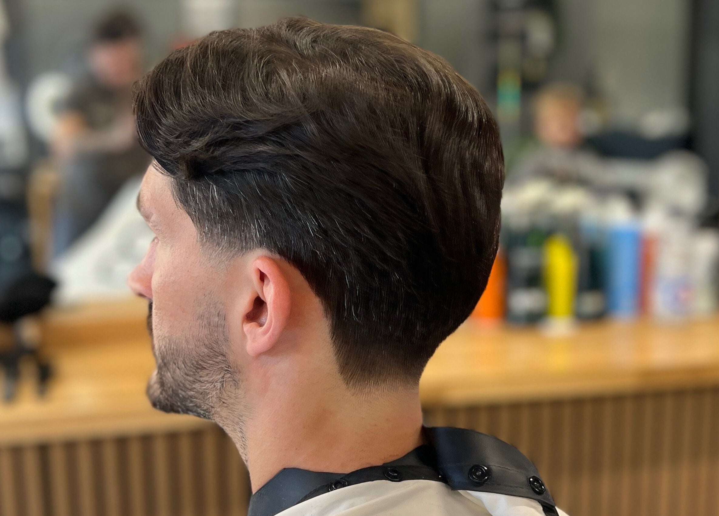 Groomed hairstyle at Moss Barber Studio, Llantrisant, Wales, GB, showcasing a sleek and modern haircut.