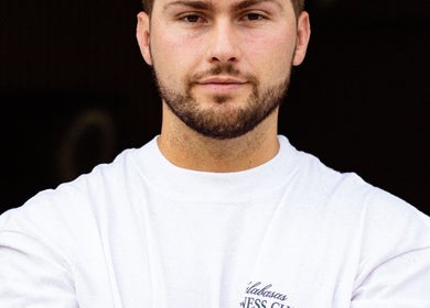 Client at Moss Barber Studio, Llantrisant, Wales, GB shows a fresh haircut in a relaxed pose.