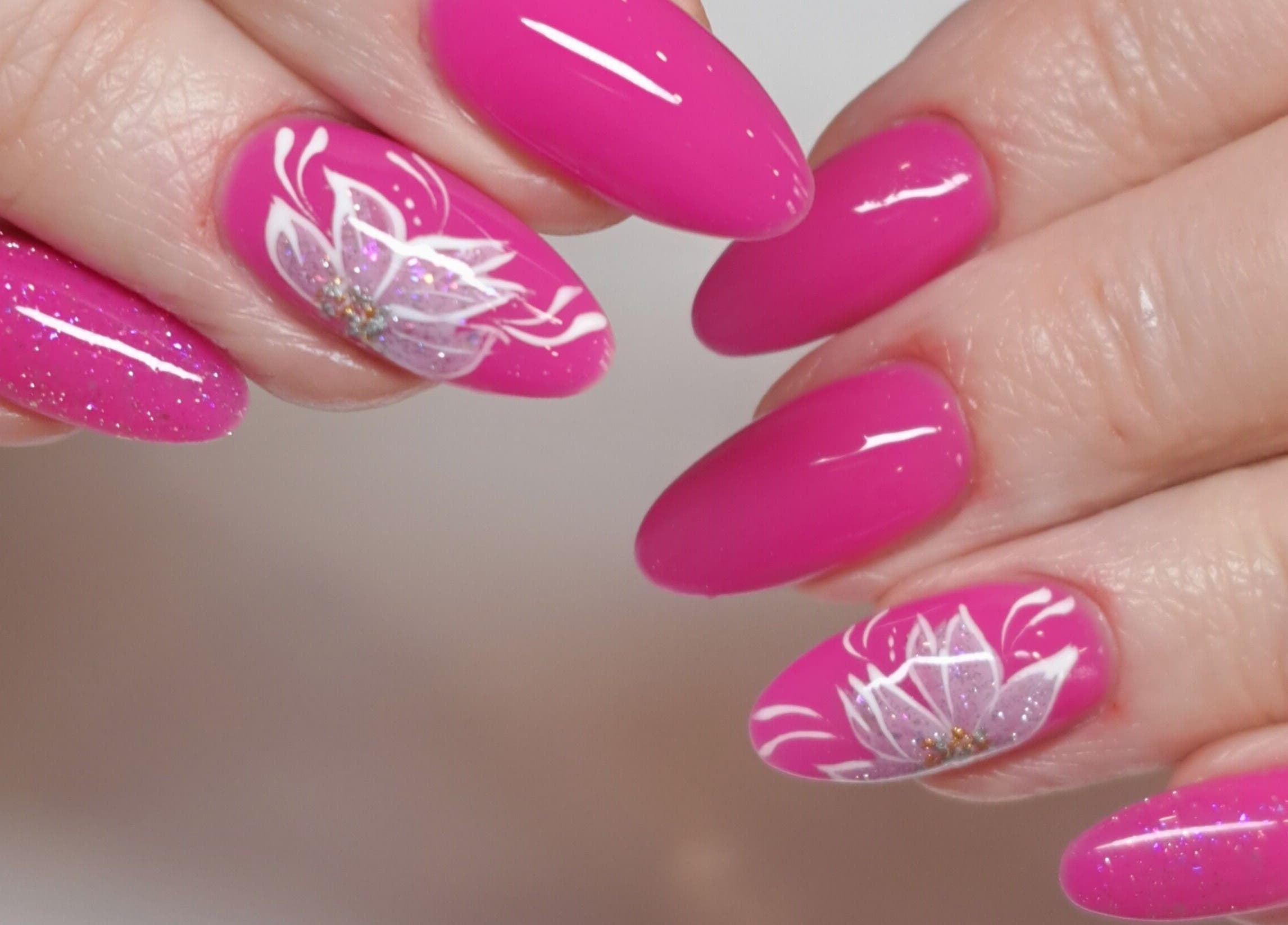 Stunning pink floral nail art at MB Beauty Nails, Spalding, England, GB, featuring delicate white flowers.