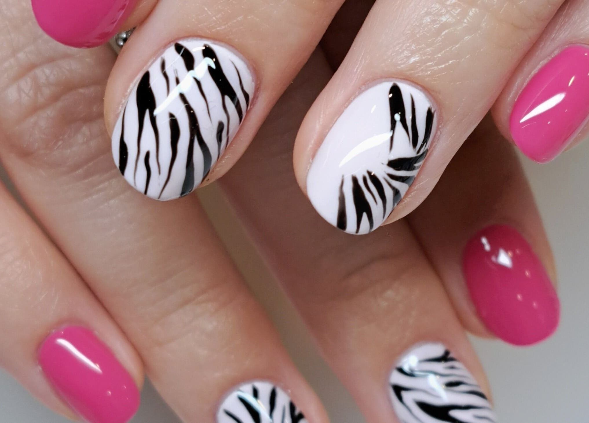 Zebra and pink nail art at MB Beauty Nails, Spalding, England, GB showcasing stylish designs.