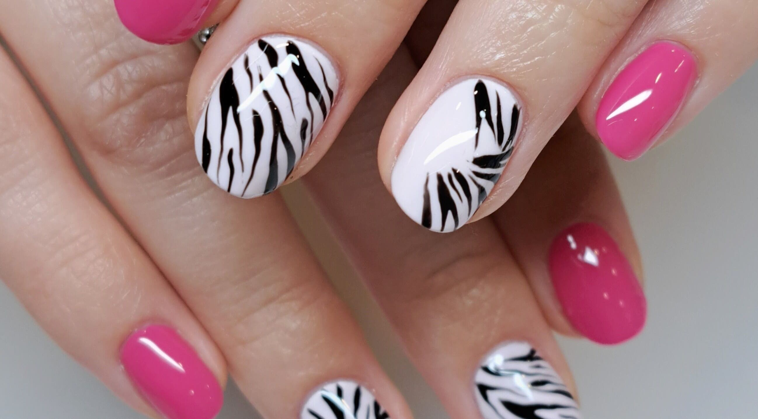 Zebra and pink nail art at MB Beauty Nails, Spalding, England, GB showcasing stylish designs.