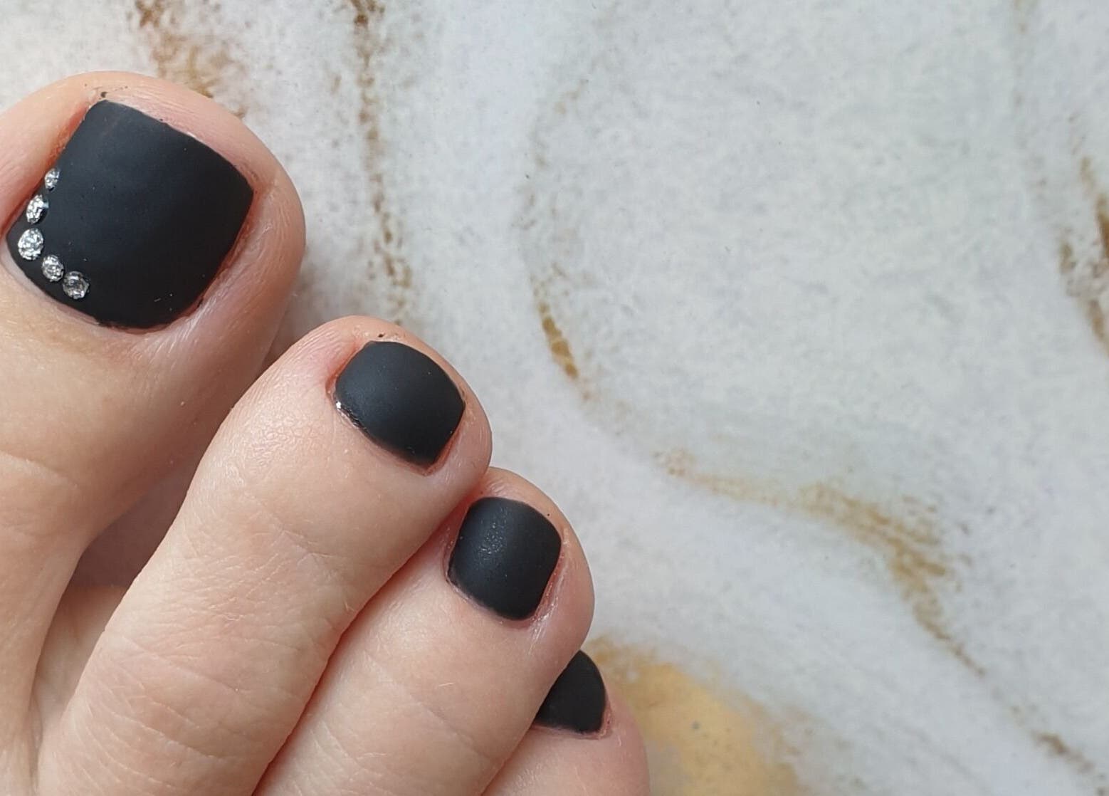 Black and gem nail art on toes at MB Beauty Nails, Spalding, England, GB.