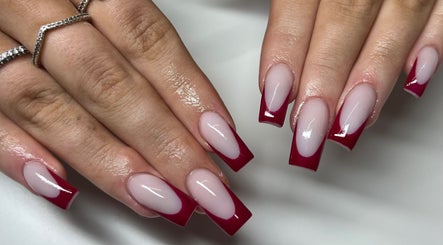 Elegant red French manicure by Beauty by Emily, Plymouth, England, GB. Perfectly polished for a classy finish.
