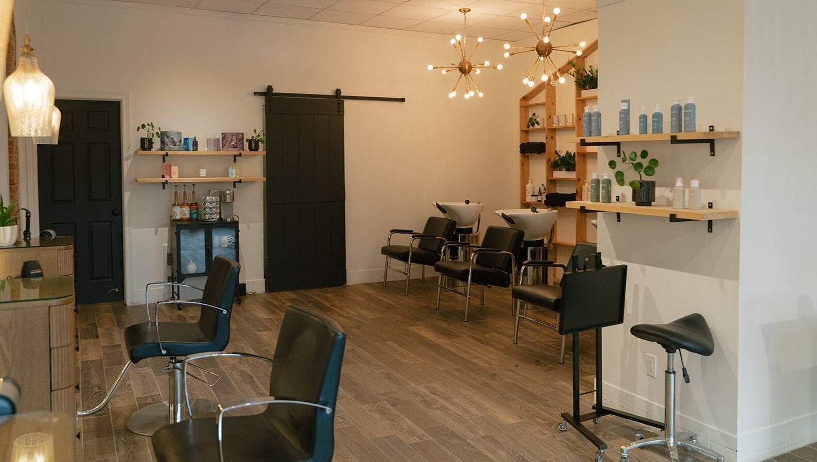 Modern salon interior at Glow Hair Studio, Thorold, Ontario, CA with stylish chairs and lighting.