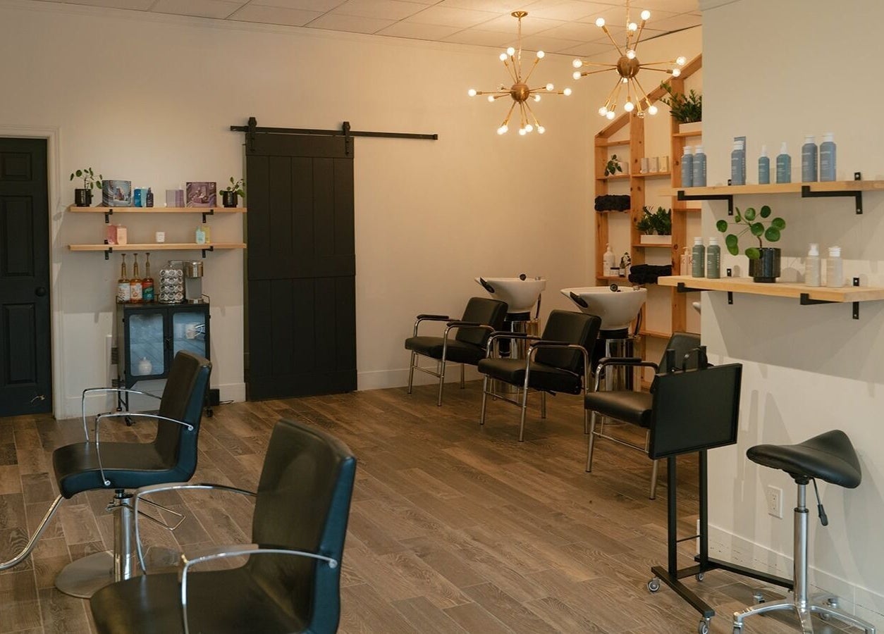 Modern salon interior at Glow Hair Studio, Thorold, Ontario, CA with stylish chairs and lighting.