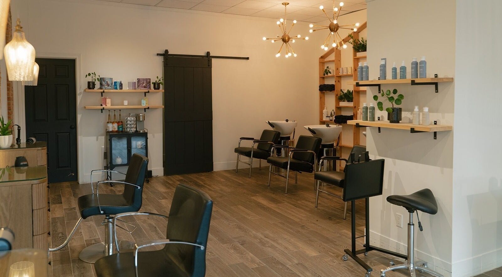 Modern salon interior at Glow Hair Studio, Thorold, Ontario, CA with stylish chairs and lighting.