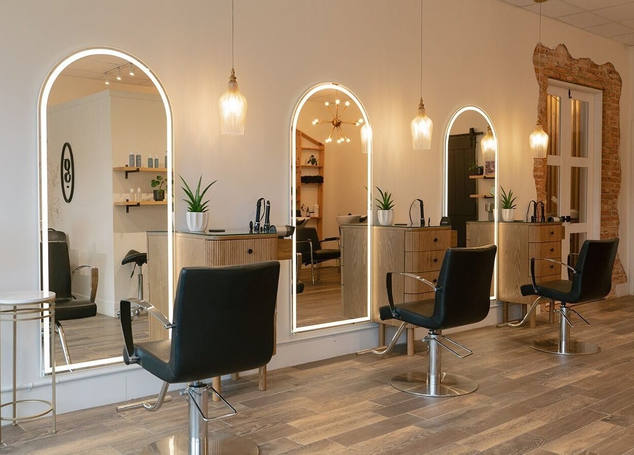 Elegant salon stations at Glow Hair Studio, Thorold, Ontario, CA with modern decor and cozy lighting.