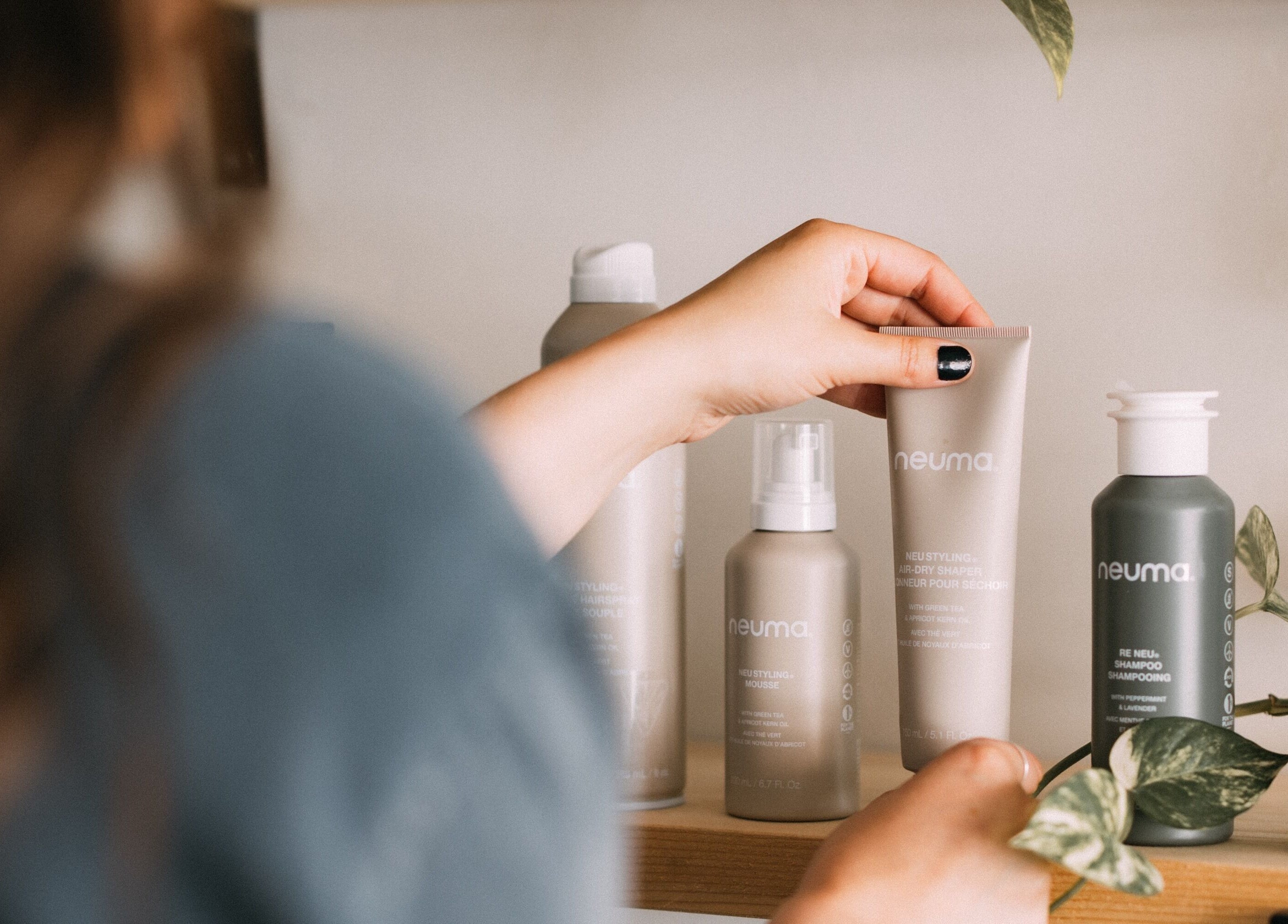Person selecting hair products at Glow Hair Studio, Thorold, Ontario, CA.