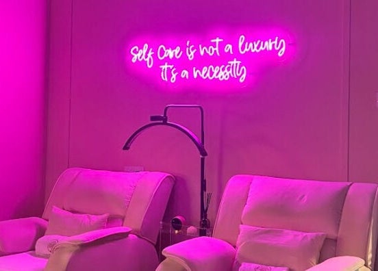 Cozy spa chairs under pink neon sign at The Ruumah Spa Signature, Petaling Jaya, Selangor, MY.