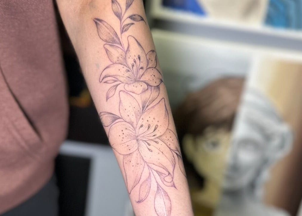 Elegant floral arm tattoo at Casa Amor - Coming Soon, Hamilton, Ontario, CA.
