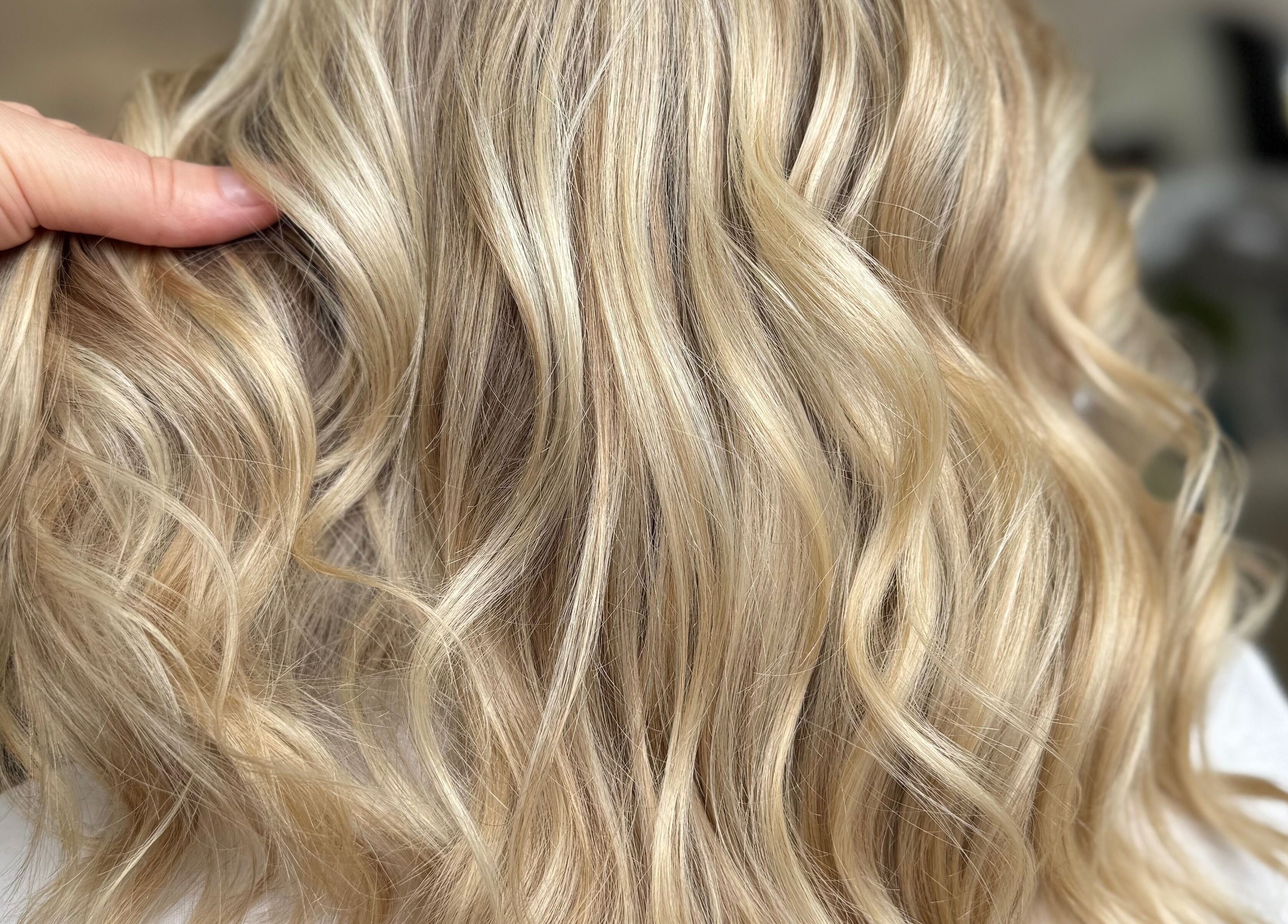 Elegant blonde curls at Casa Amor - Coming Soon, Hamilton, Ontario, CA, showcasing luxurious hair styling.