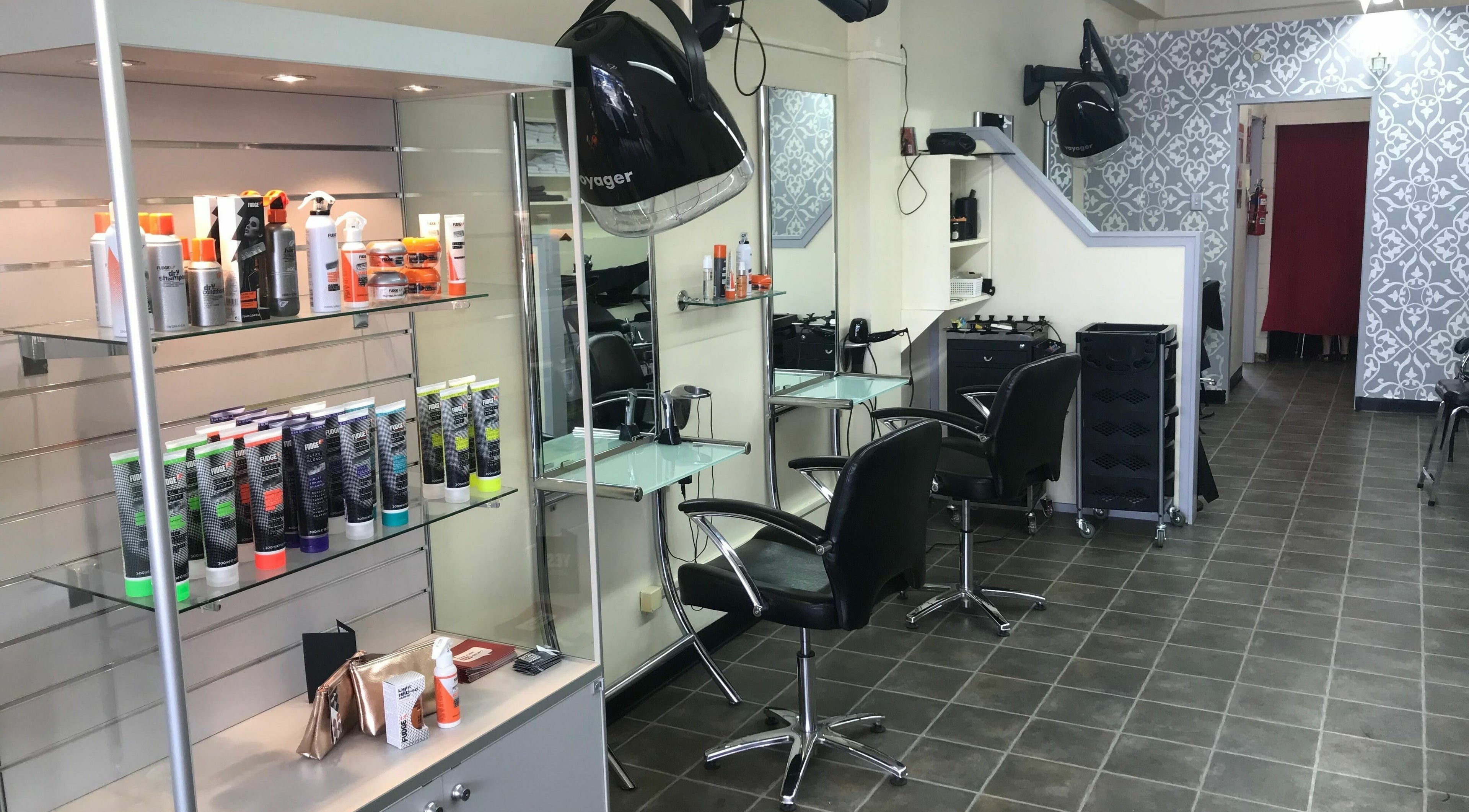 Modern styling chairs and shelves at Hair on Duke, Cambridge, Waikato, NZ, showcasing premium hair products.