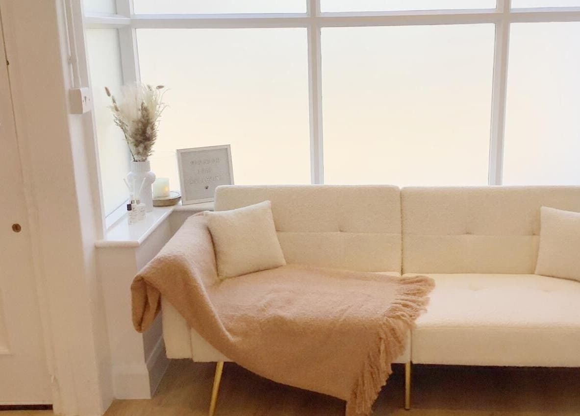 Cozy seating area at Blossom Leaf, Bognor Regis, England, GB, with a soft beige couch and elegant décor.