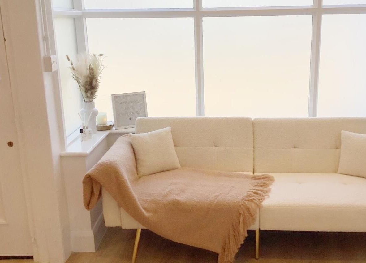 Cozy seating area at Blossom Leaf, Bognor Regis, England, GB, with a soft beige couch and elegant décor.