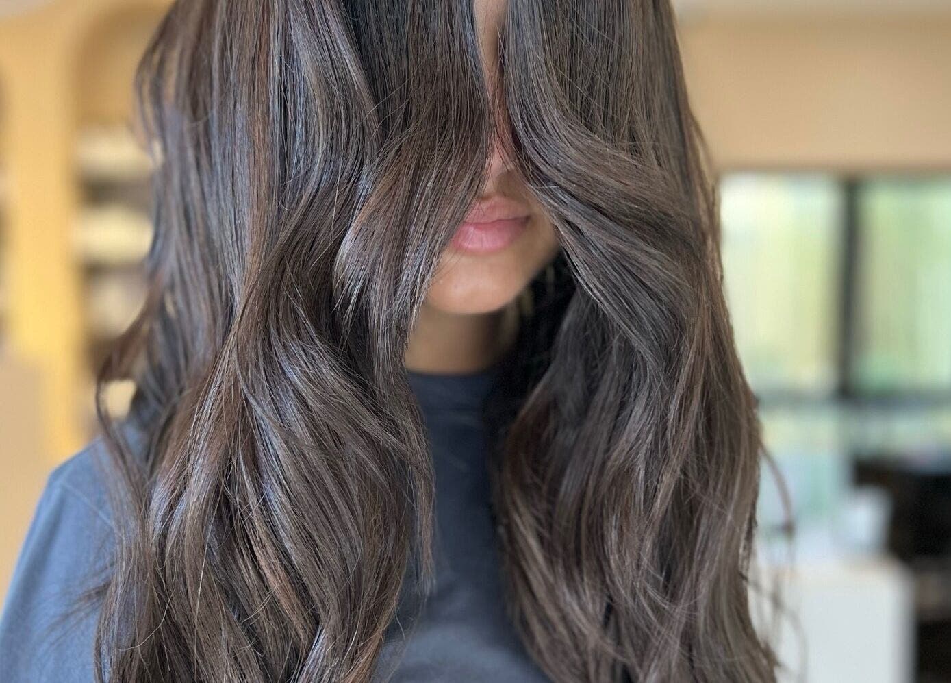 Stylish brunette hair with soft waves at h.AIRLAB Balmain, Balmain East, New South Wales, AU.