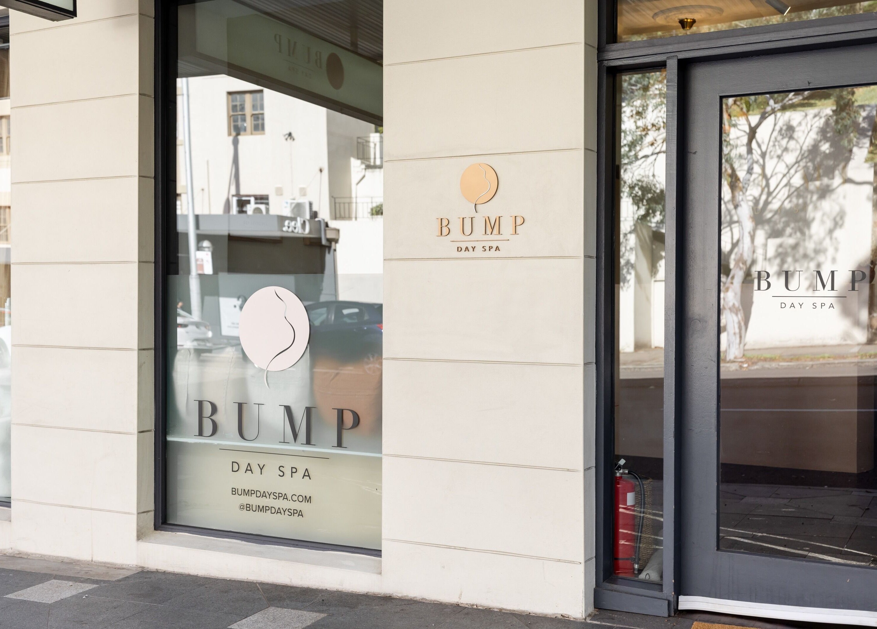 Entrance to Bump Day Spa, Double Bay, New South Wales, AU; sleek glass doors with elegant signage.
