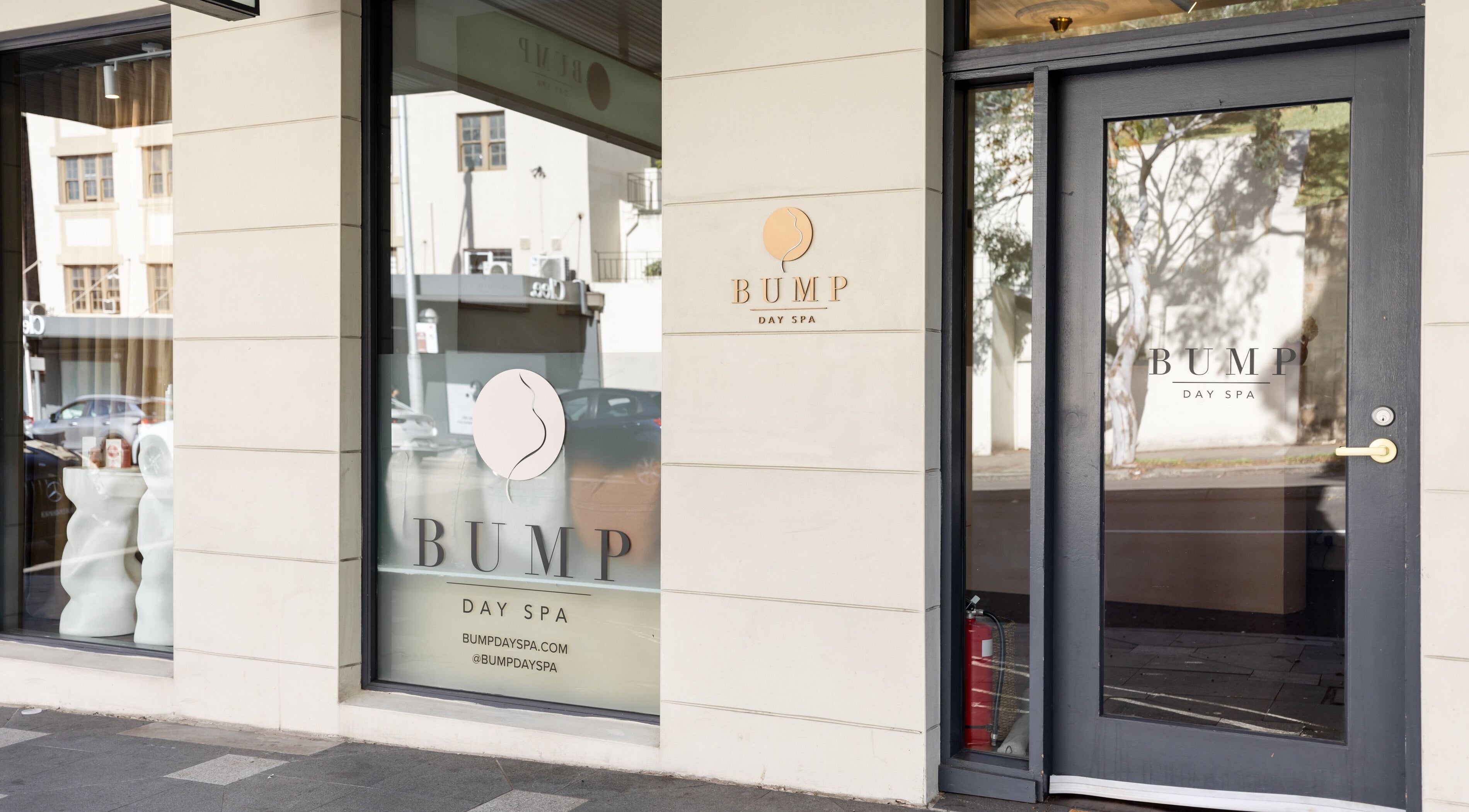 Entrance to Bump Day Spa, Double Bay, New South Wales, AU; sleek glass doors with elegant signage.