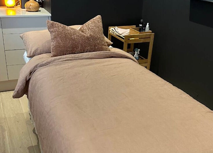 Tranquil massage room at Bump Day Spa, Double Bay, New South Wales, AU, featuring a cozy bed and soft lighting.