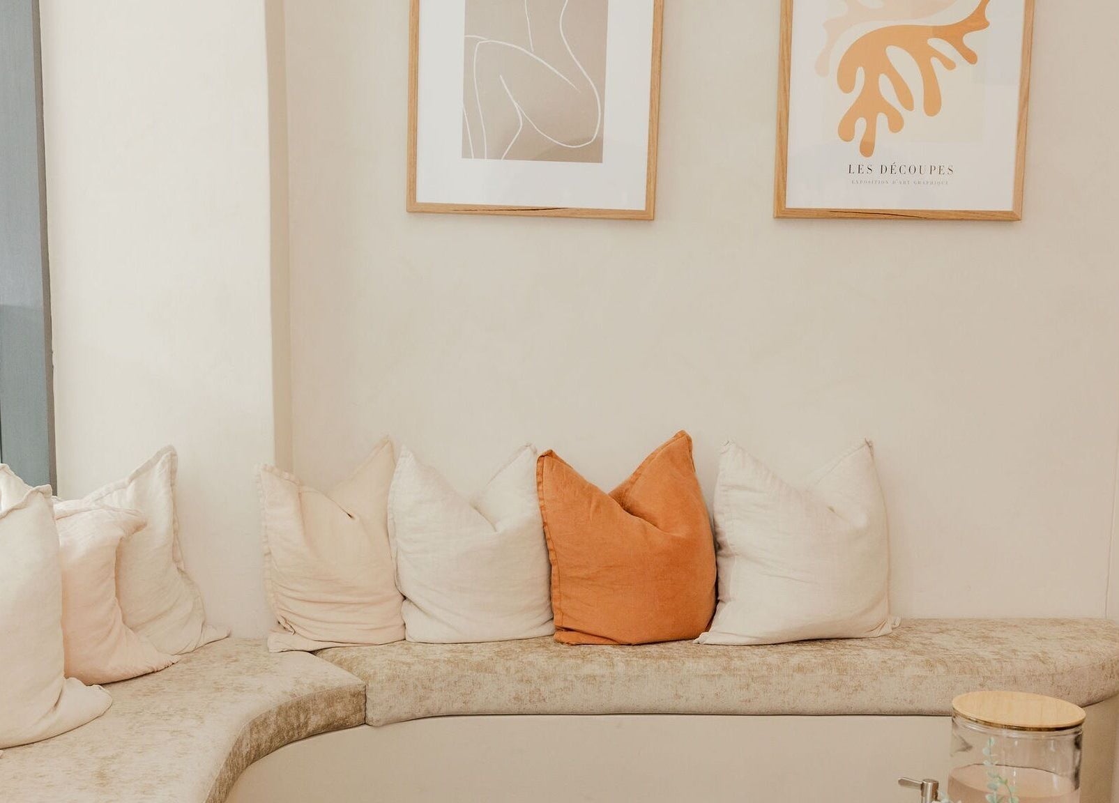 A stylish seating area at Bump Day Spa, Double Bay, New South Wales, AU, with inviting cushions and art decor.