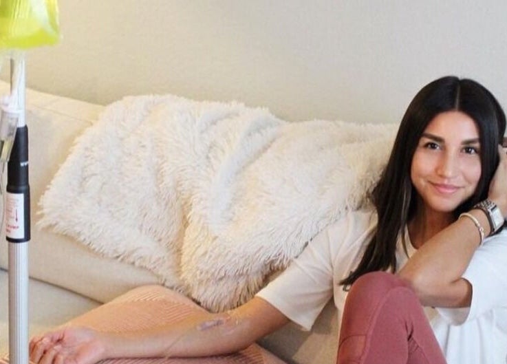 Woman enjoying IV therapy at Trio Pilates Vitamin Injection Pop up, Bridgewater, Massachusetts, US.