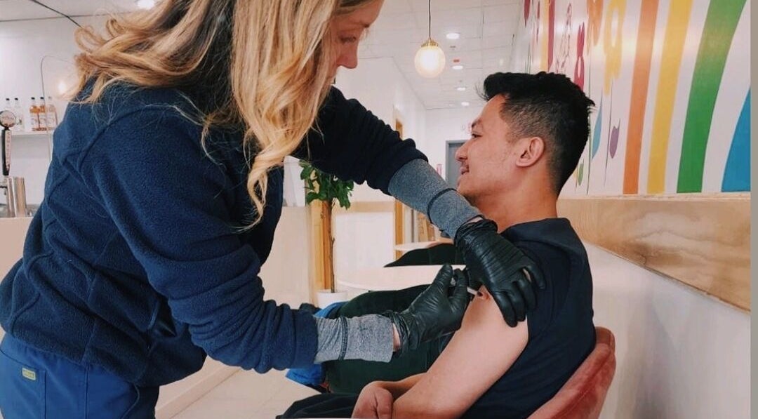 Professional administering injection at Vitamin Injection Pop Up 1st Saturday of the Month, Raynham, Massachusetts, US.