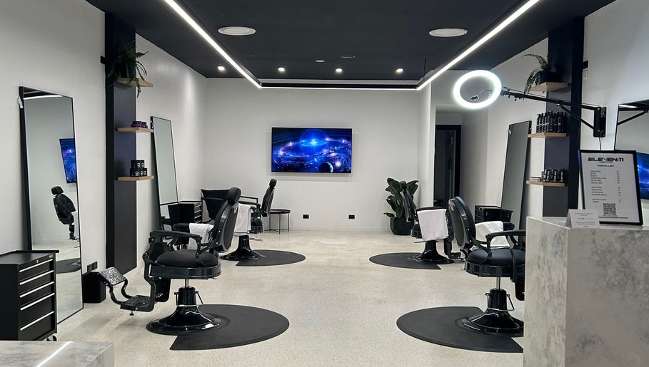 Modern interior of Eleven 11 Barber Studios in Coomera, Queensland, AU, featuring stylish barber chairs and sleek design.