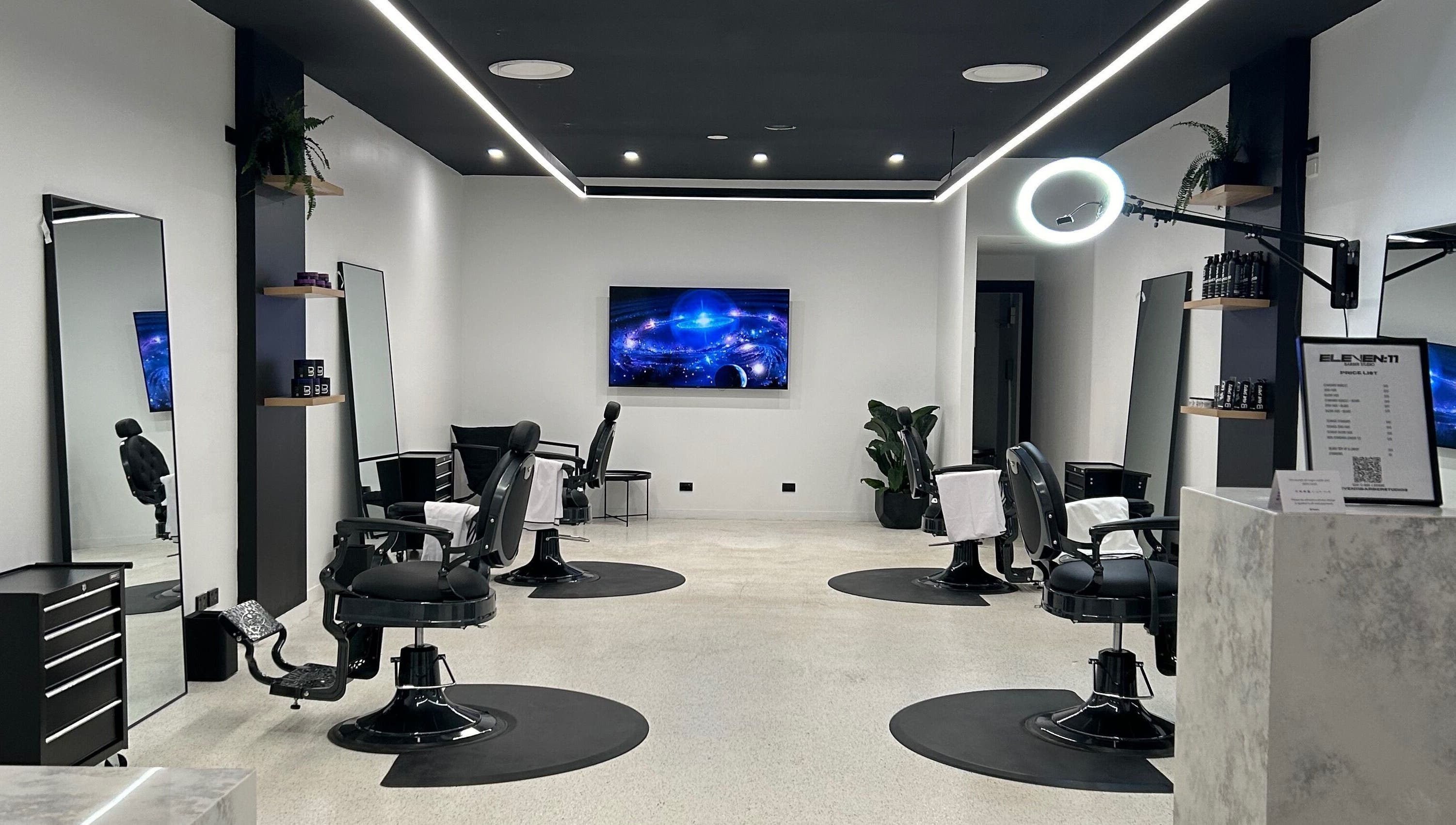 Modern interior of Eleven 11 Barber Studios in Coomera, Queensland, AU, featuring stylish barber chairs and sleek design.
