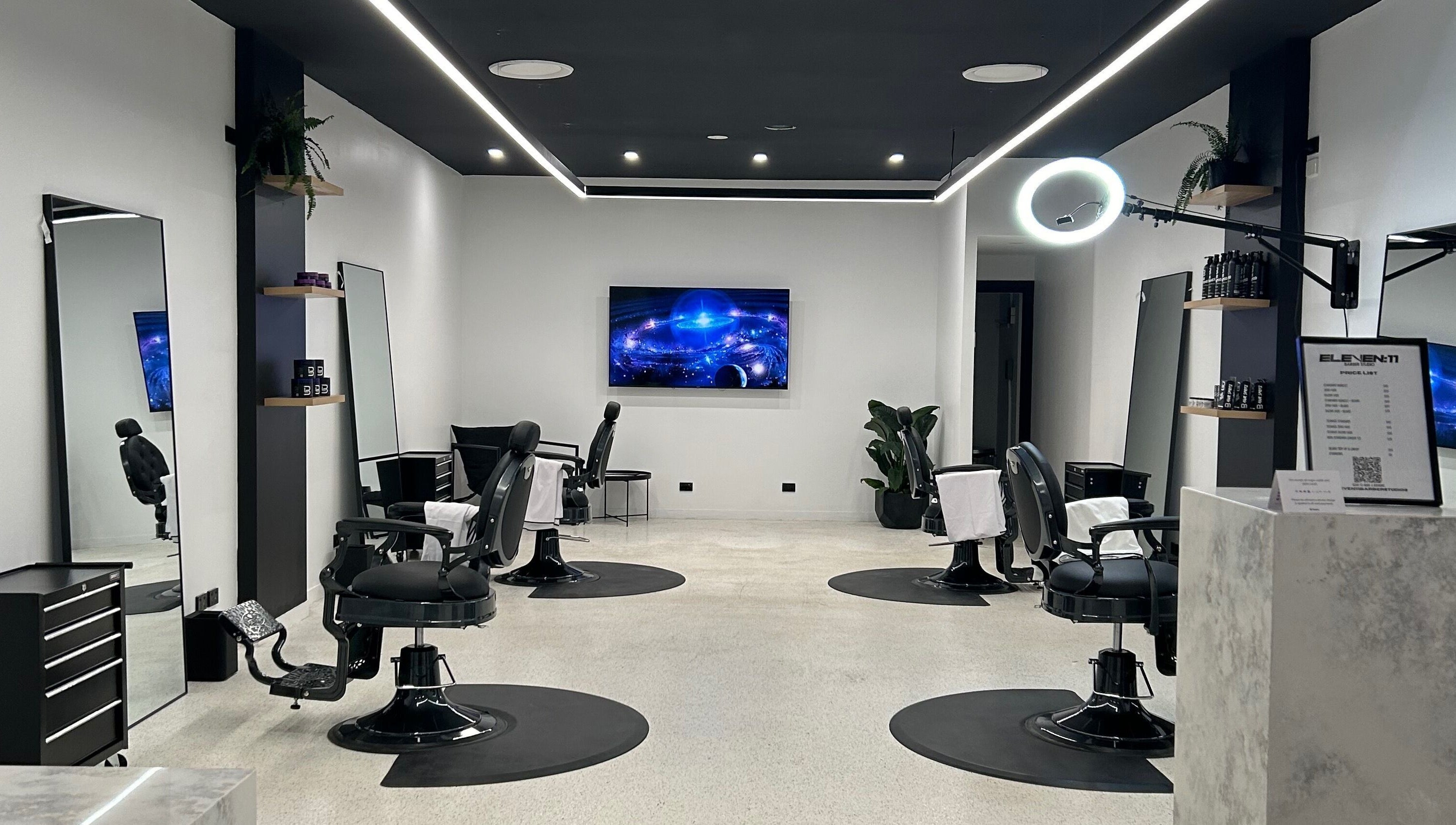 Modern interior of Eleven 11 Barber Studios in Coomera, Queensland, AU, featuring stylish barber chairs and sleek design.