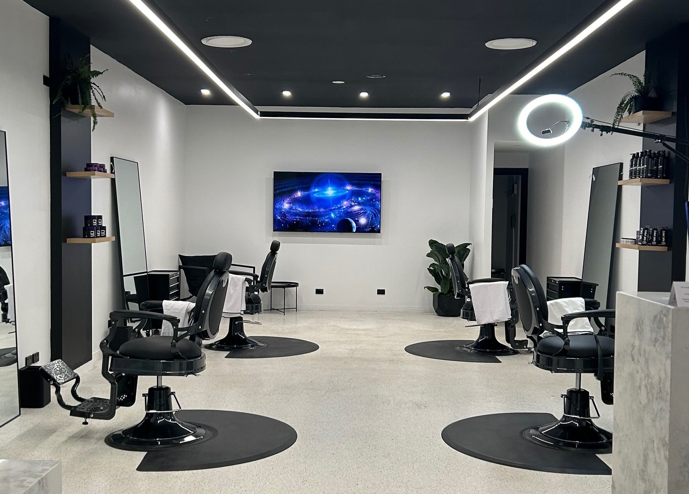 Modern interior of Eleven 11 Barber Studios in Coomera, Queensland, AU, featuring stylish barber chairs and sleek design.