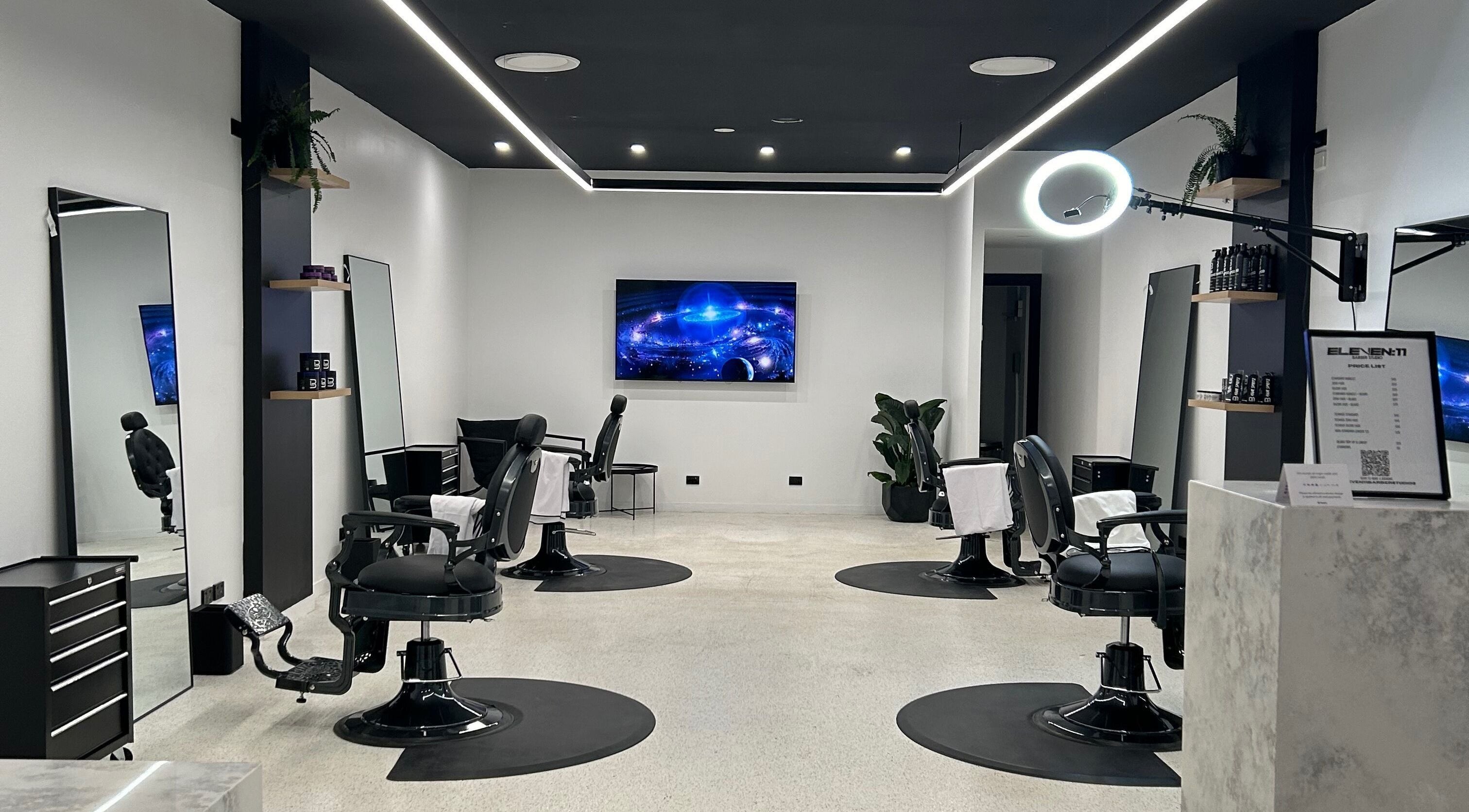 Modern interior of Eleven 11 Barber Studios in Coomera, Queensland, AU, featuring stylish barber chairs and sleek design.
