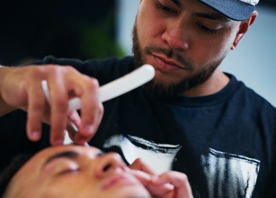 Barber at Eleven 11 Barber Studios in Coomera, Queensland, AU giving a precision trim.