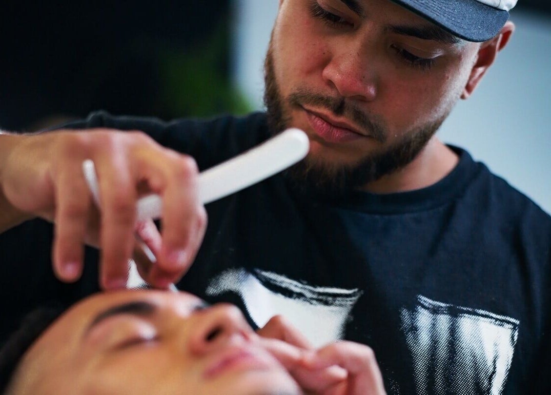 Barber at Eleven 11 Barber Studios in Coomera, Queensland, AU giving a precision trim.