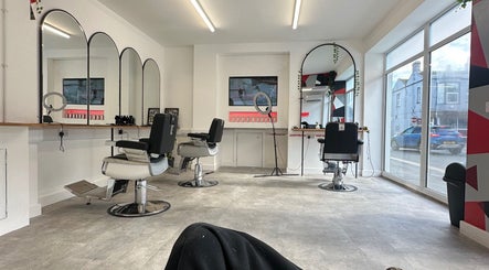 Interior of HeroGapped Barber Studio, Bognor Regis, with stylish chairs and mirrors.